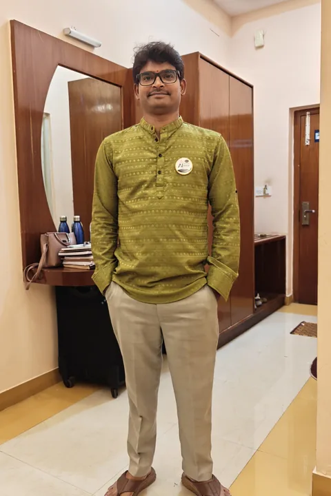 Full-length photograph of Krishna Kummari in an olive-green kurta and beige trousers.